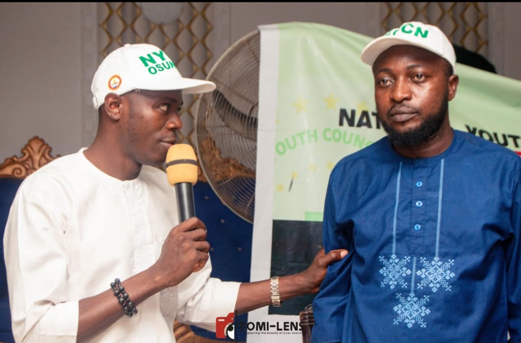 OmoAkin speaking with microphone during NYCN state executive dialogue
